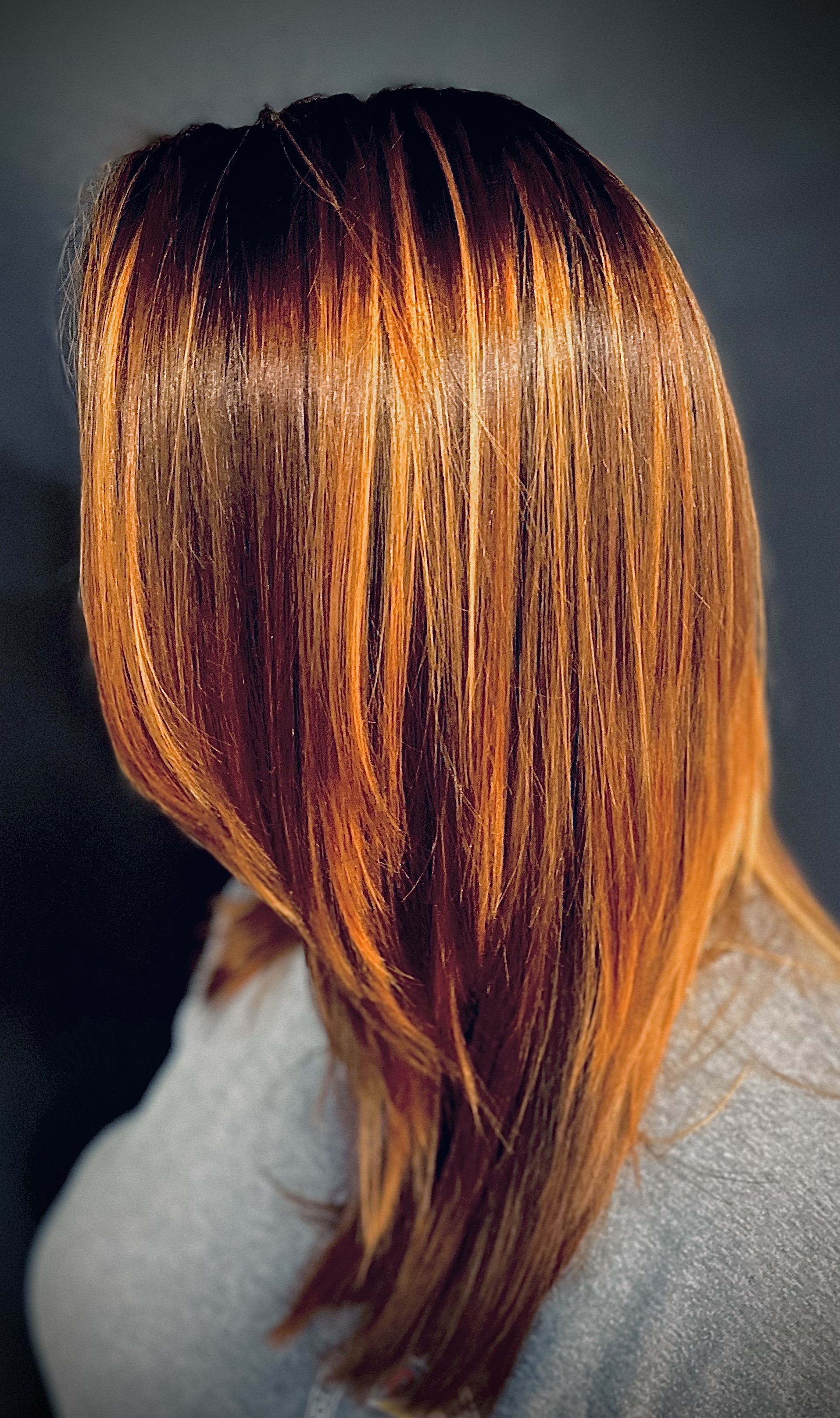 Long copper and red layered hair from behind