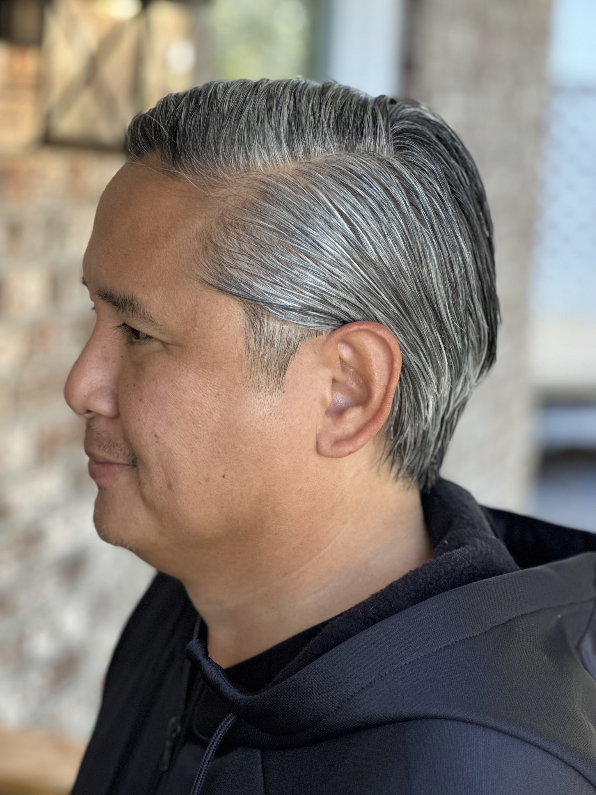 Short grey side-swept cut for a man
