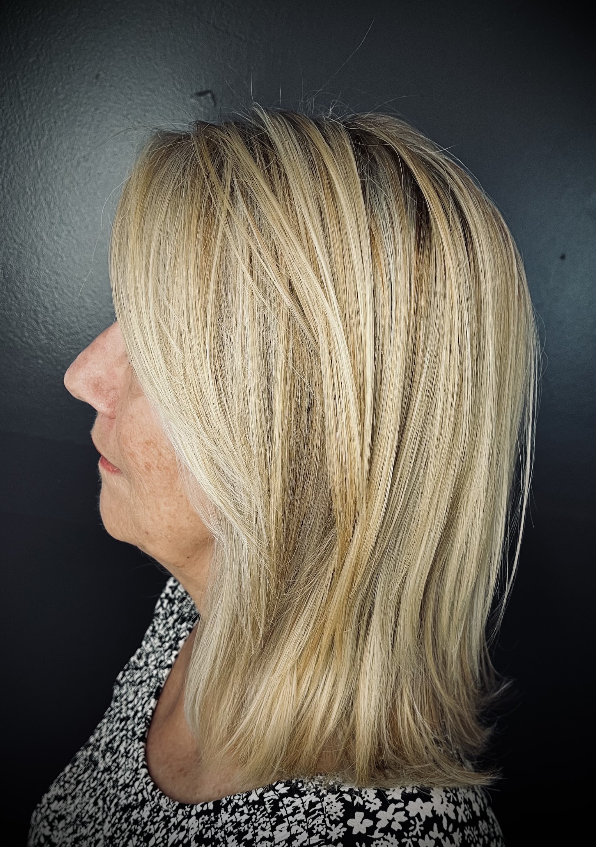 Honey blonde shoulder-length cut seen from the side
